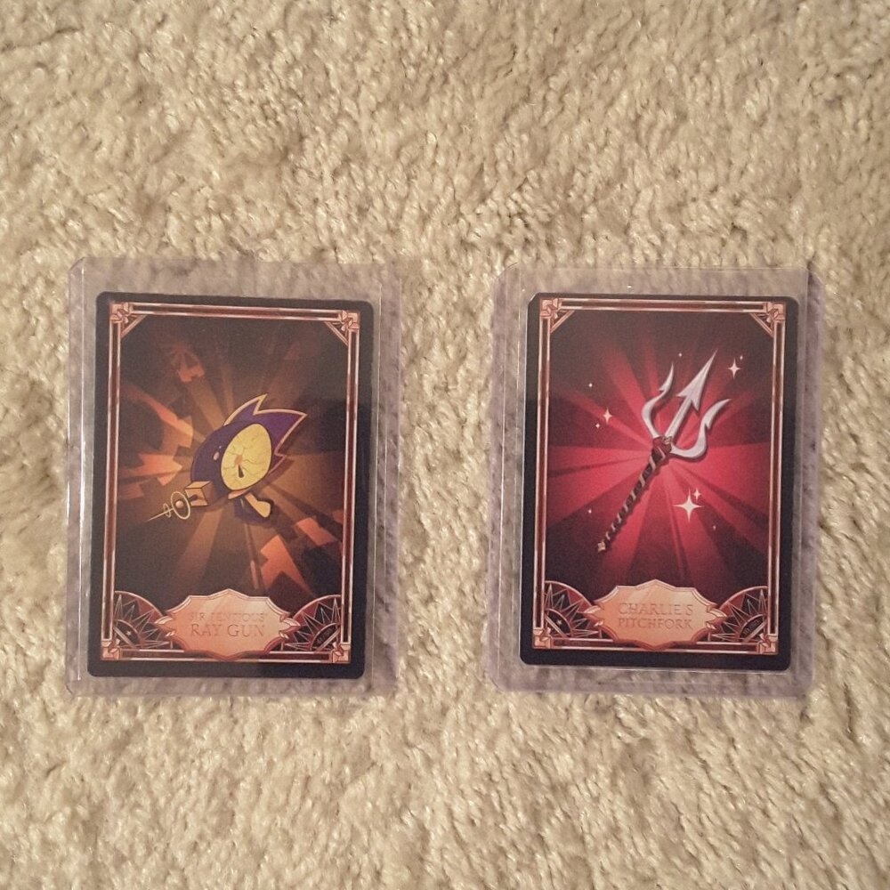 Hazbin Hotel Trading Card Lot of 2 Sir Pentious' Ray Gun and Charlie's Pitchfork